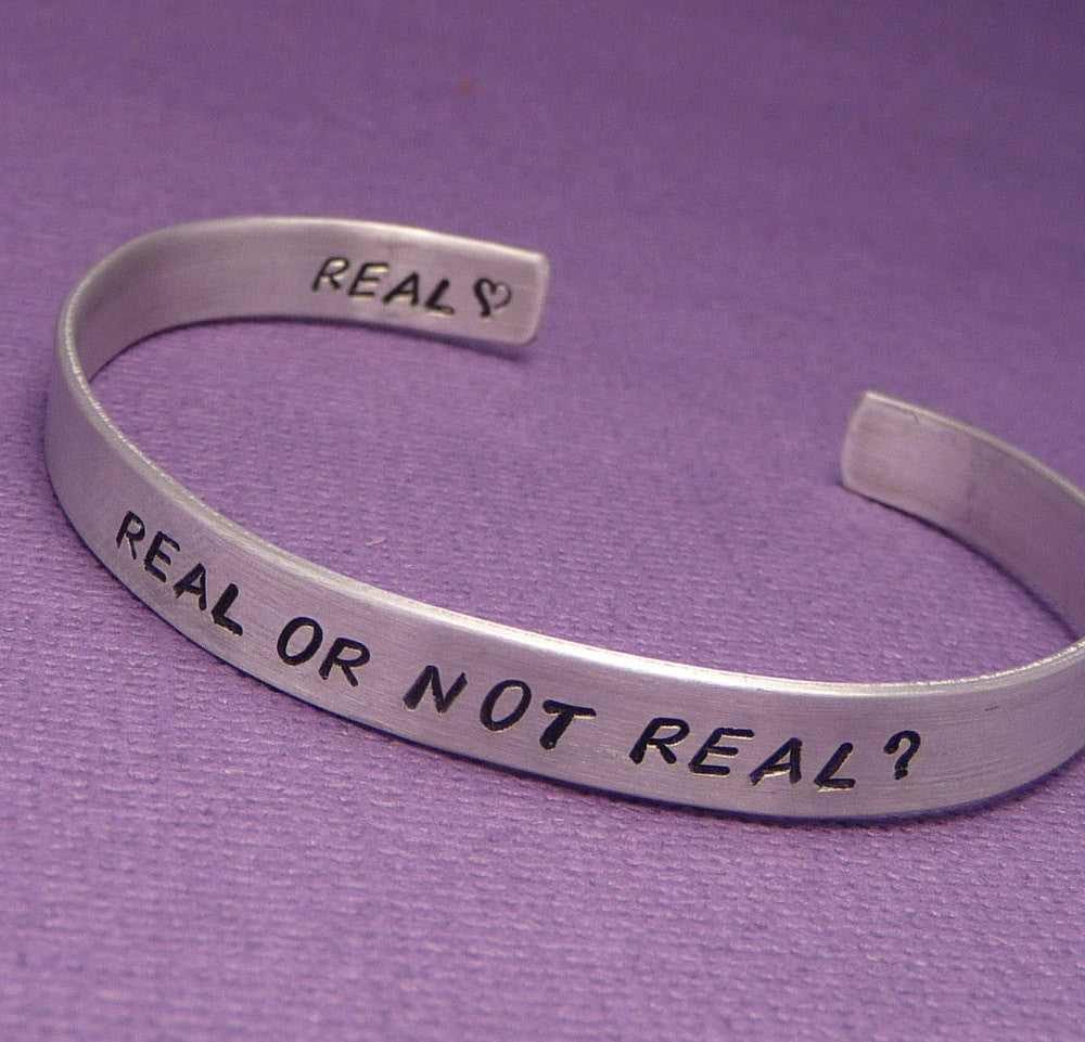 Hunger Games Inspired - Real Or Not Real - A Double Sided Hand Stamped Aluminum Bracelet