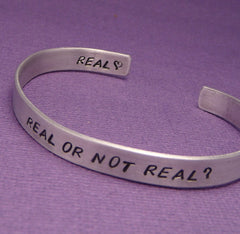 Hunger Games Inspired - Real Or Not Real - A Double Sided Hand Stamped Aluminum Bracelet