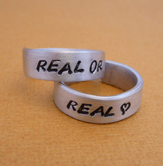 Hunger Games Inspired - Real or Not Real and Real - A Pair of Hand Stamped Aluminum Rings